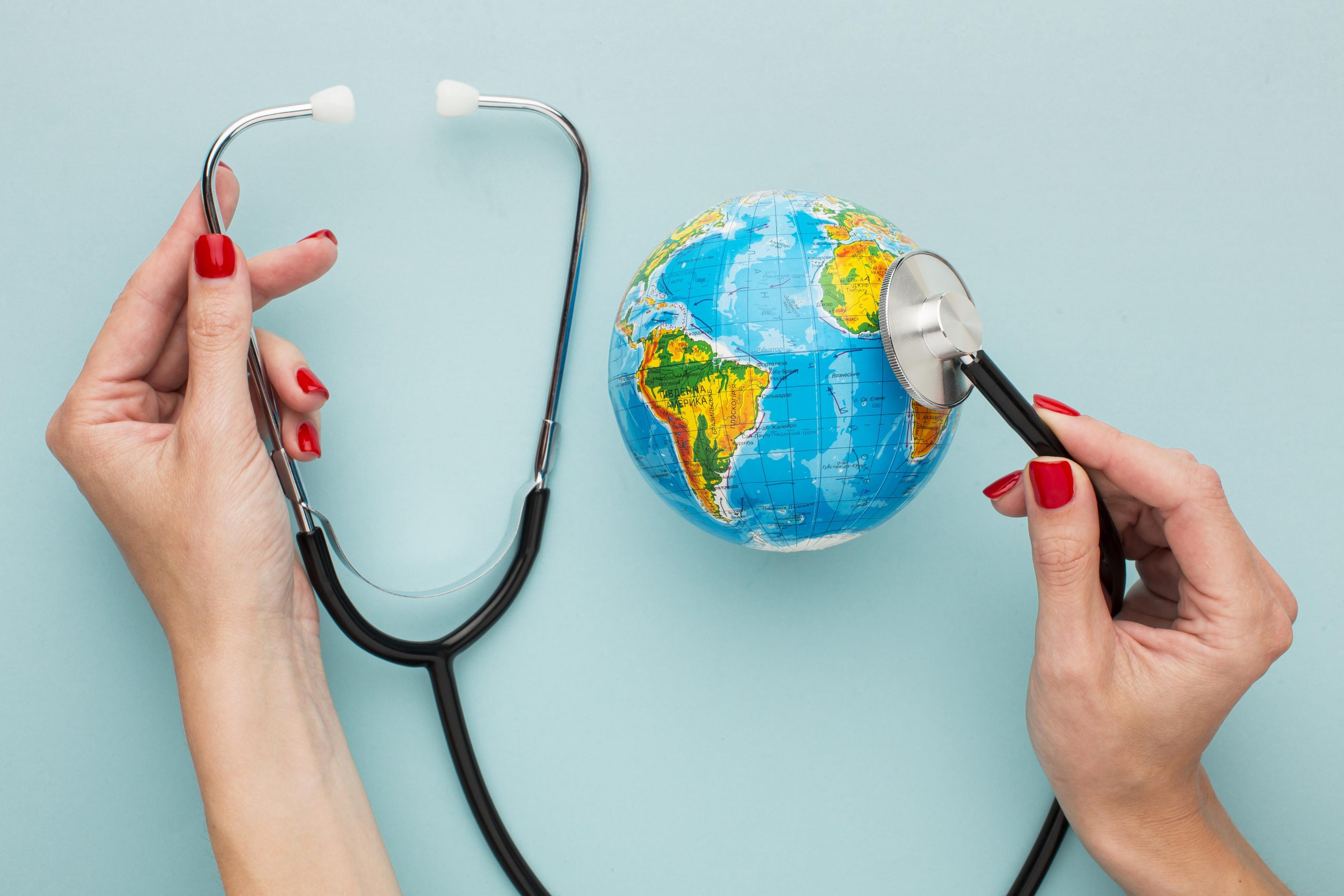 top-view-hands-holding-stethoscope-with-globe