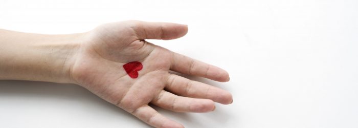 Aerial view of heart drawing on hand on white background