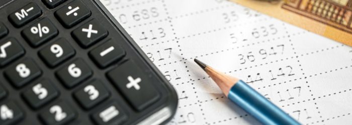 Calculator, money and pencil close-up on a blurred background, the concept of tax calculations and finance.