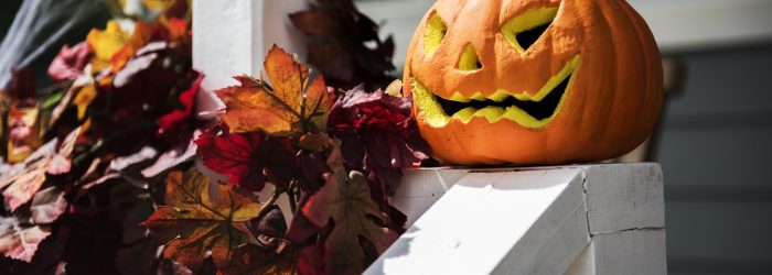 Halloween pumpkins and decorations outside a house