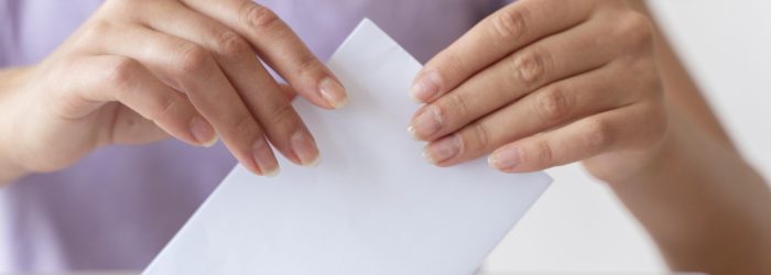 person-placing-its-vote-box