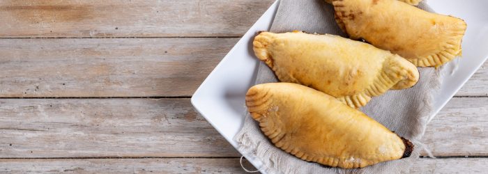 Pumpkin empanadillas for Halloween or Thanksgiving's Day on wooden table
