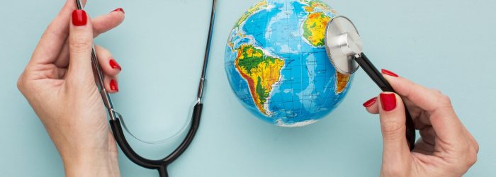 top-view-hands-holding-stethoscope-with-globe